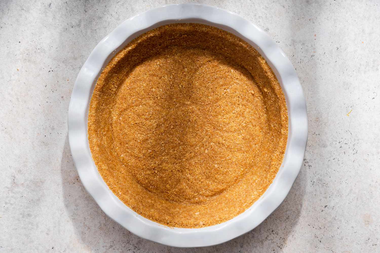 Graham cracker crust pressed into the pie pan for no-bake pumpkin pie recipe