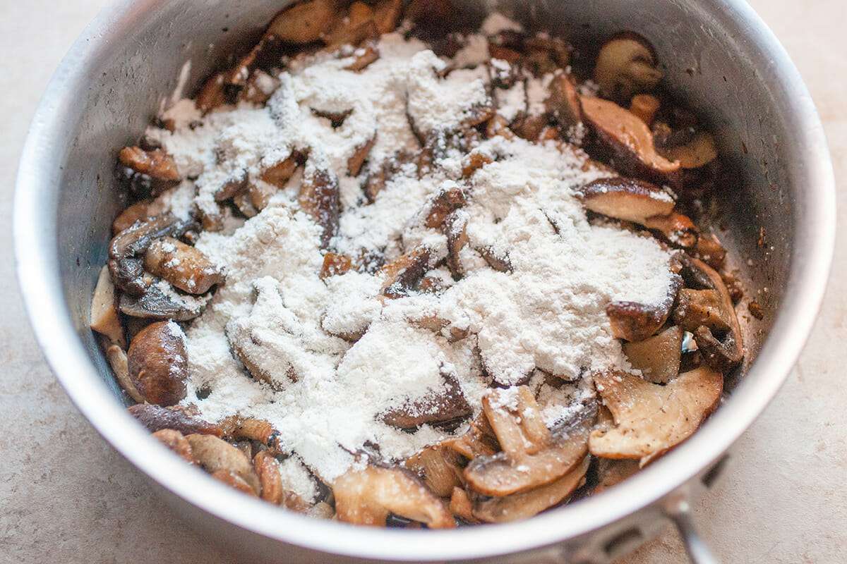 Fetuccine Alfredo with Mushrooms adding flour to mushrooms