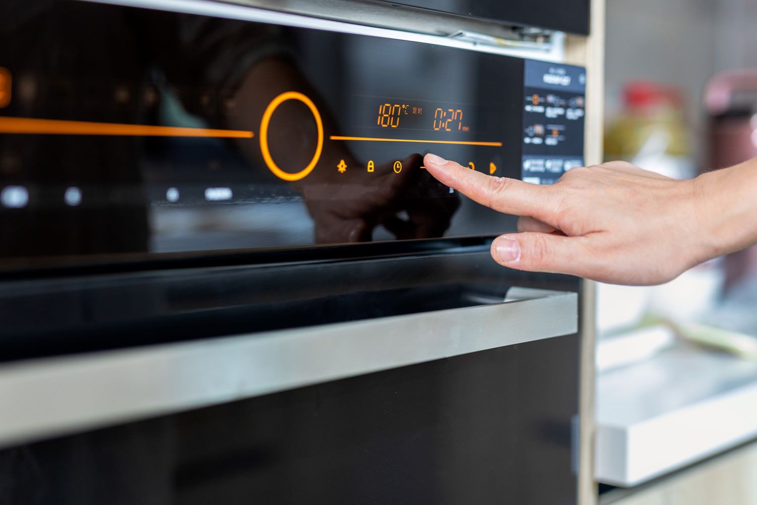 Photo of a person turning on their oven