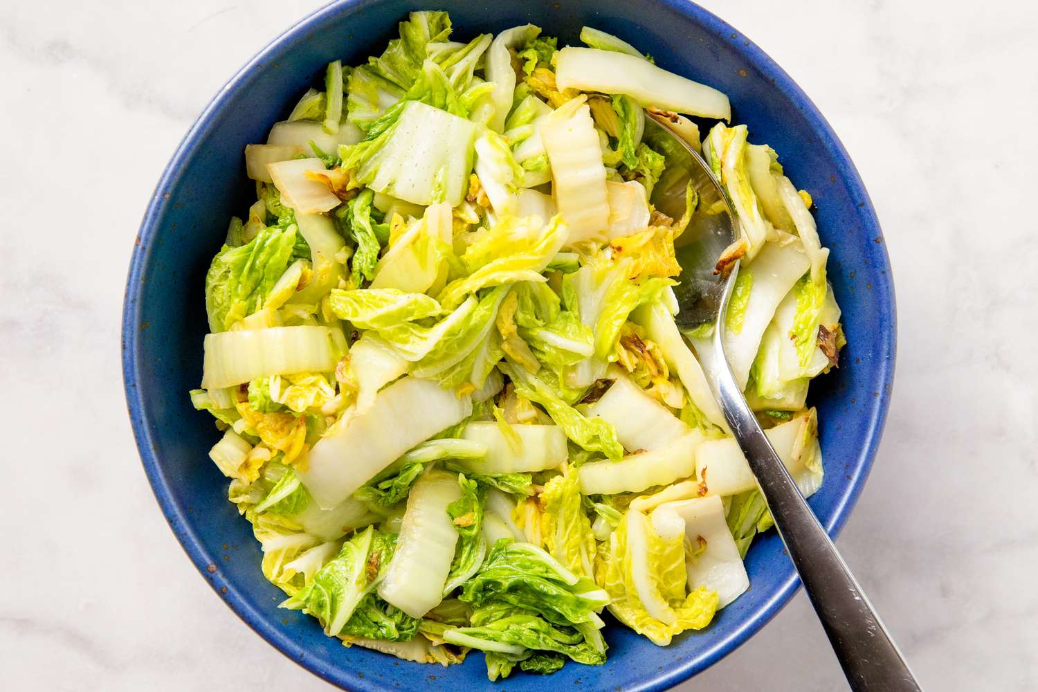 bowl of Stir Fried Napa Cabbage with a spoon