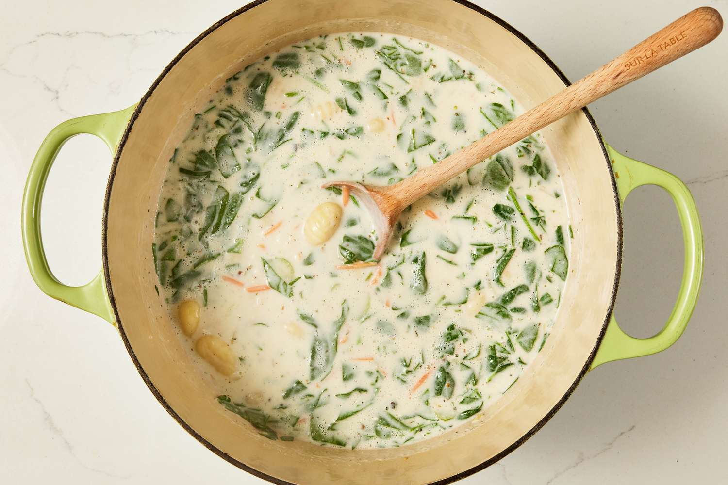 Copycat Olive Garden chicken and gnocchi soup after spinach is stirred into the Dutch oven