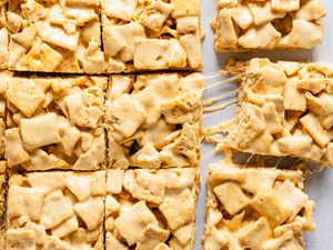 Cereal and marshmallow dessert bars cut into squares one slightly pulled away