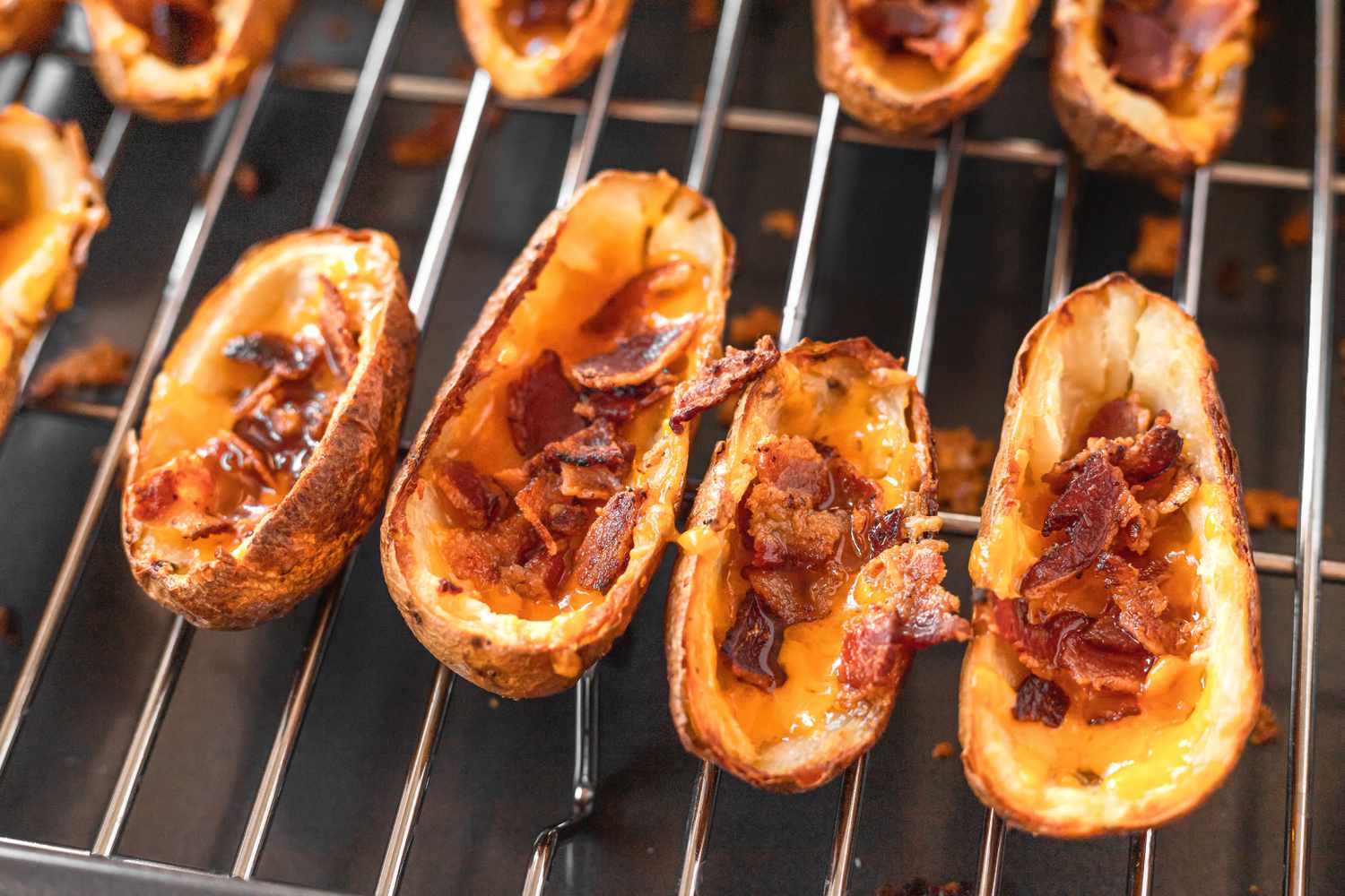 Potato skins covered in shredded cheese and bacon