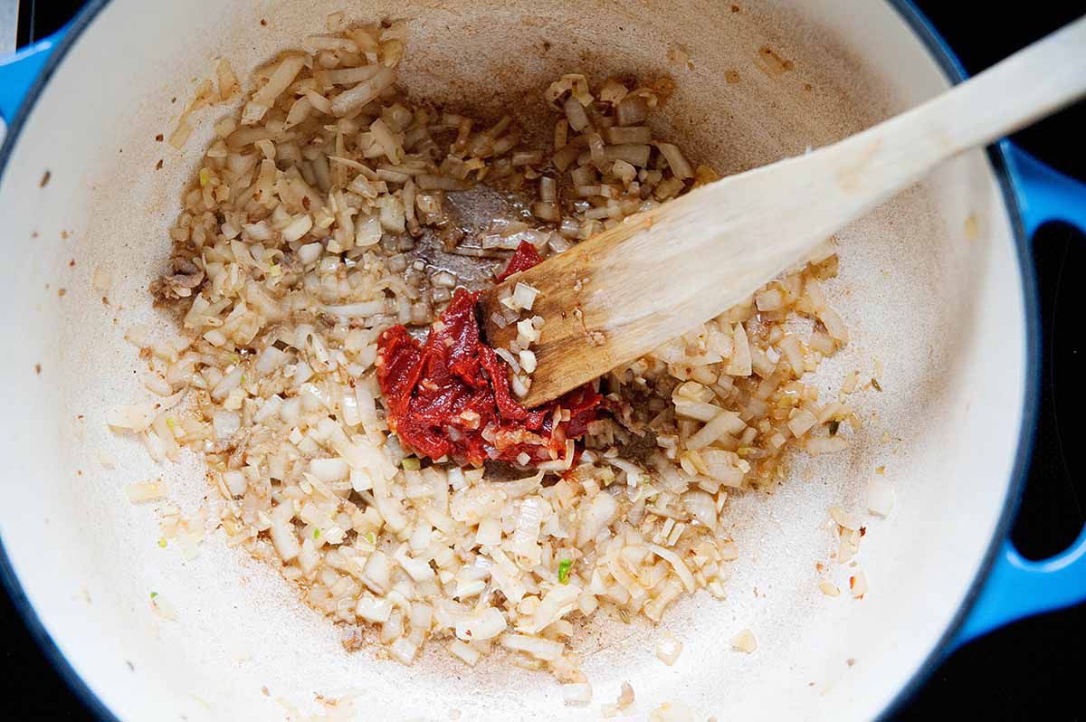 Creamy Tomato Tortellini Soup -- cooking sausage, onions, tomato paste in a pot