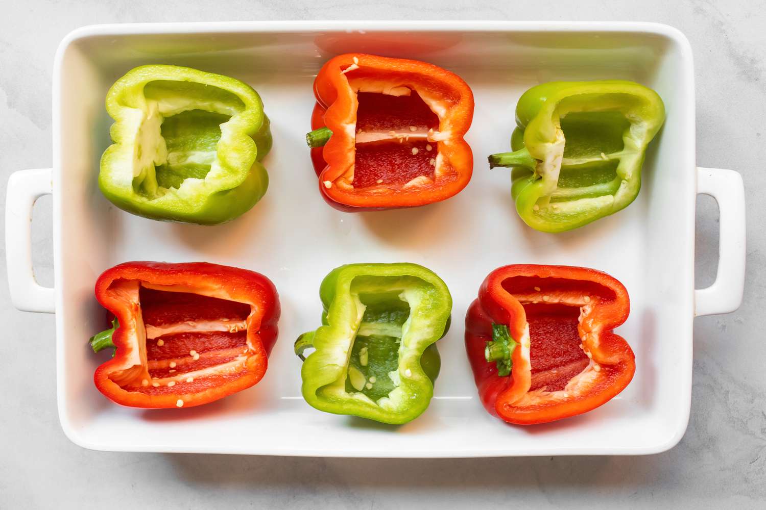 Halved Bella Peppers in a a Casserole Dish for Philly Cheesesteak Stuffed Peppers Recipe