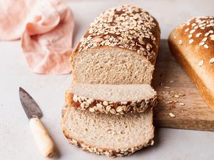 Front view of a loaf of a partially sliced loaf of oat bread 
