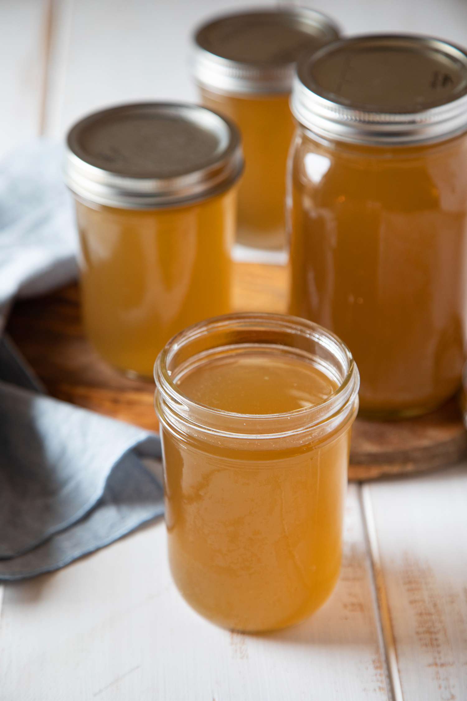 Mason jars filled with beef broth.