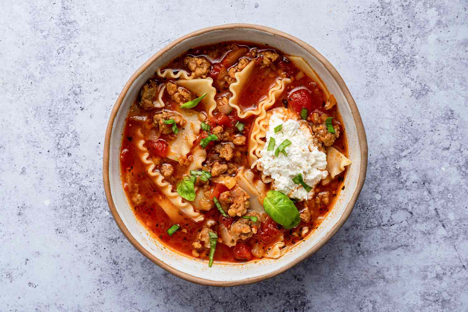 Bowl of Lasagna Soup Topped With Ricotta and Basil
