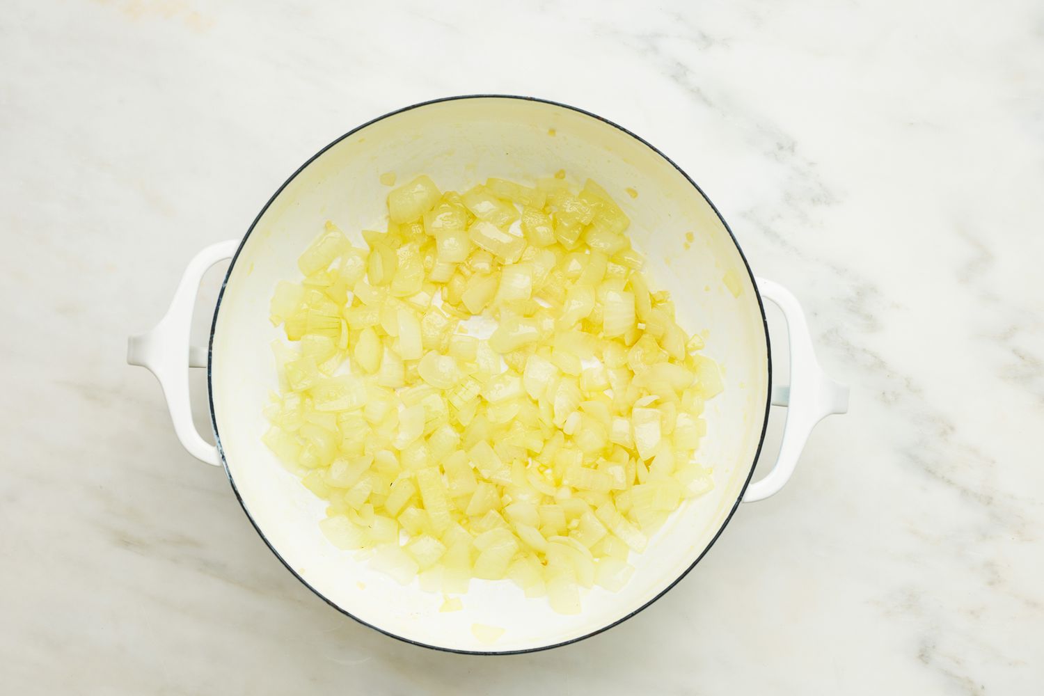 Chopped onions cooked in a Dutch oven for meatball sub soup recipe