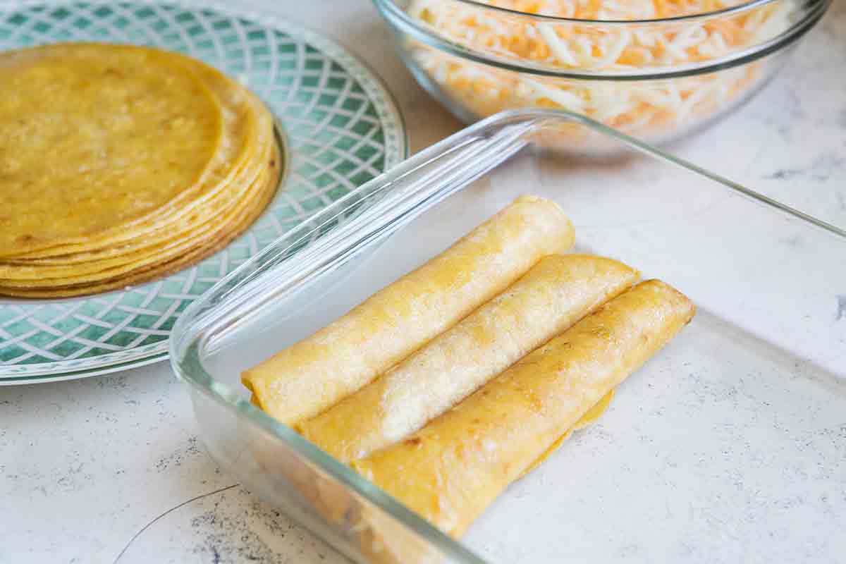 add rolled tortillas to enchilada casserole dish
