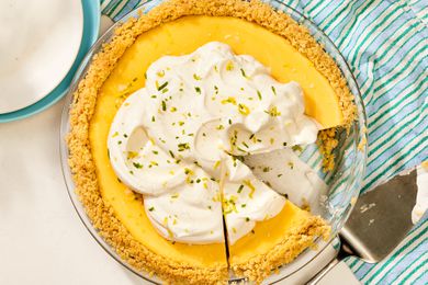 An Atlantic Beach pie with a graham cracker crust, topped with whipped cream, and partially sliced
