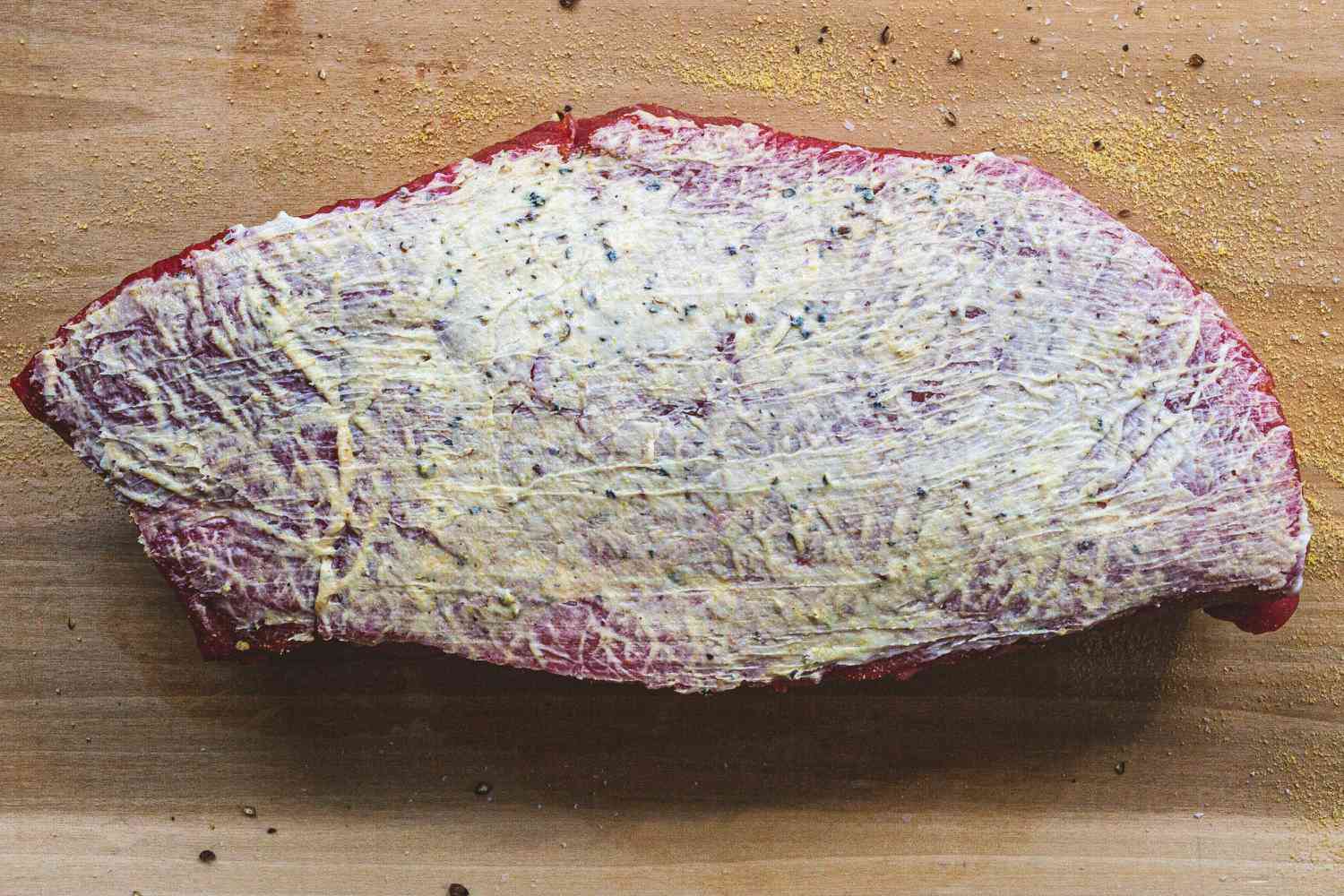 Seasoning steak to show how to cook london broil.