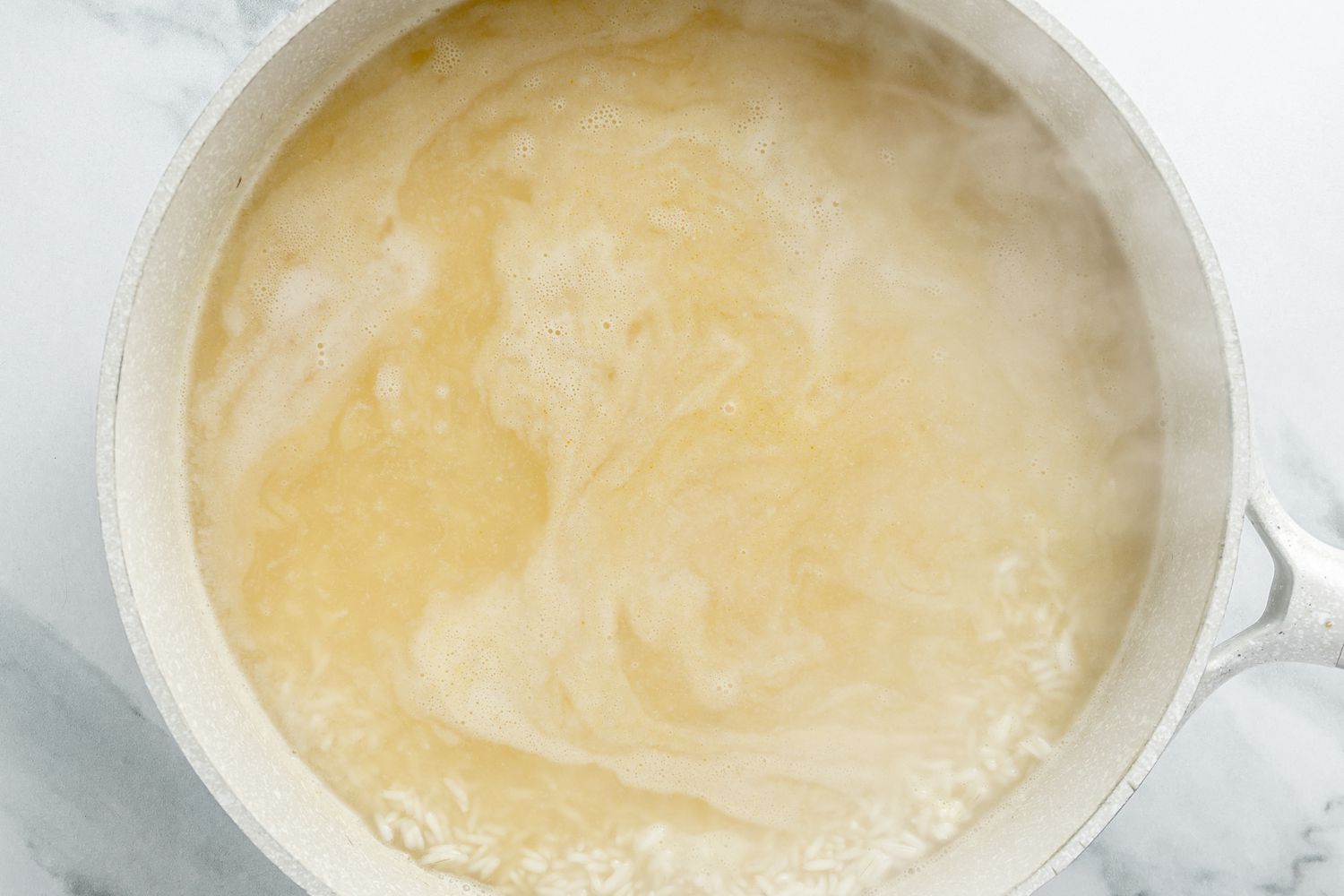 Rice Boiling in a Pot of Chicken Stock for Dirty Rice With Shrimp