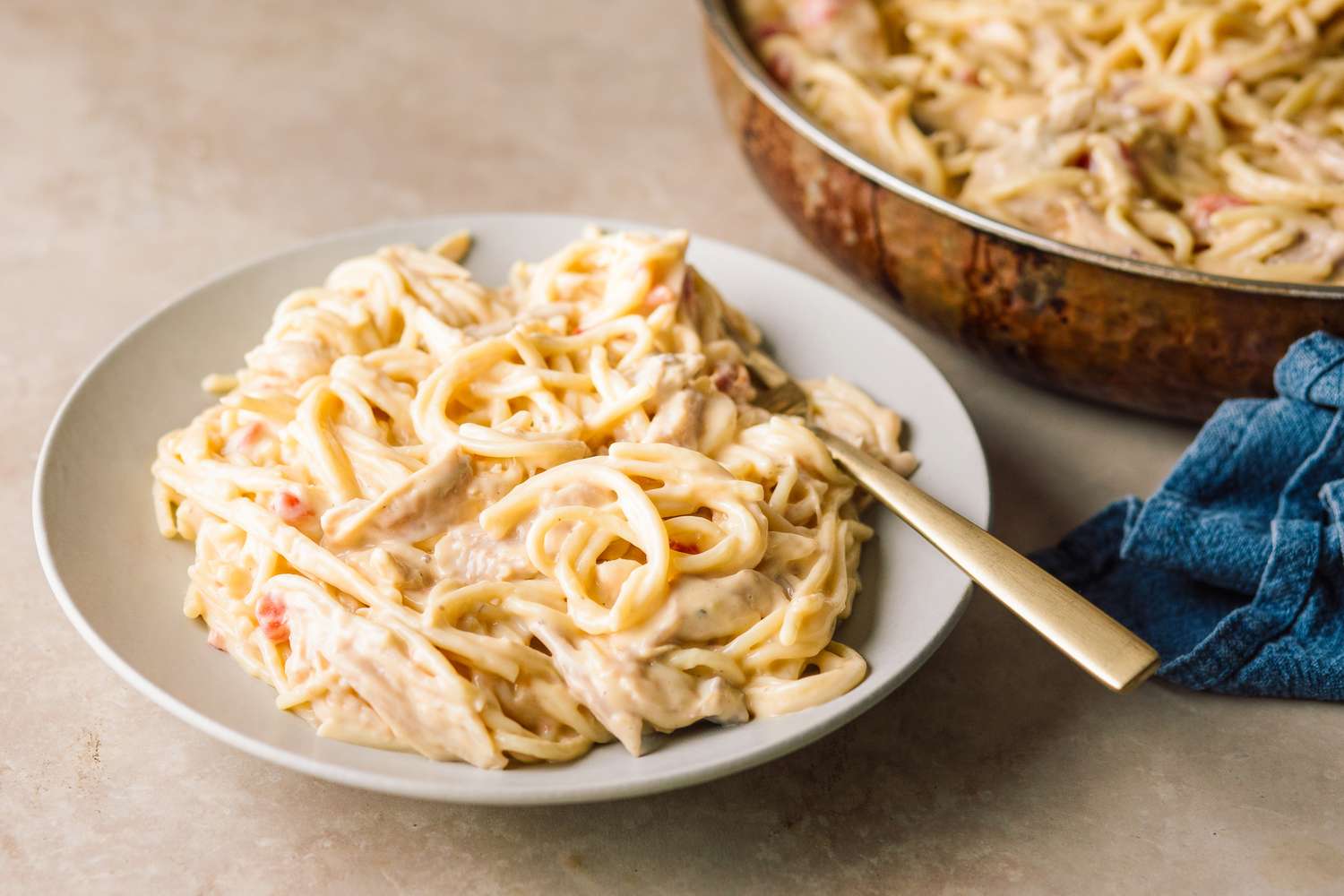 Chicken Queso Spaghetti on a plate with a fork