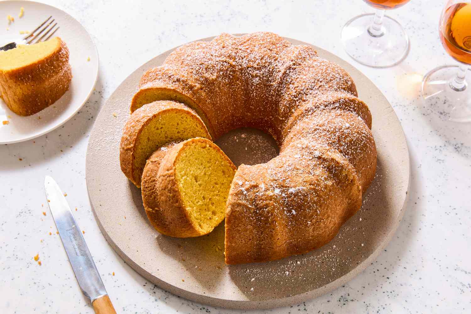 My Mom's Wine Cake bundt on a platter with two slices cut