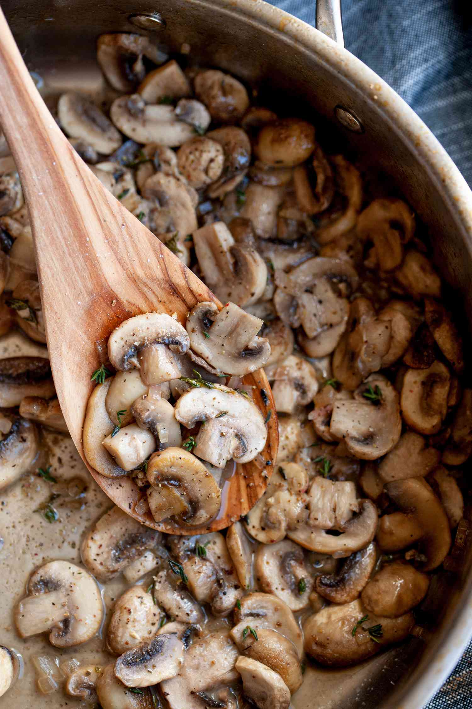sautéed mushrooms on wooden spoon