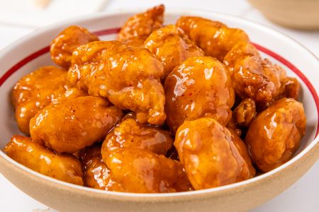 A dish of orange chicken in a bowl