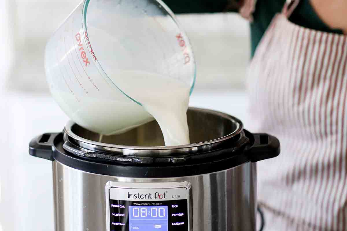Yogurt being poured into a pressure cooker