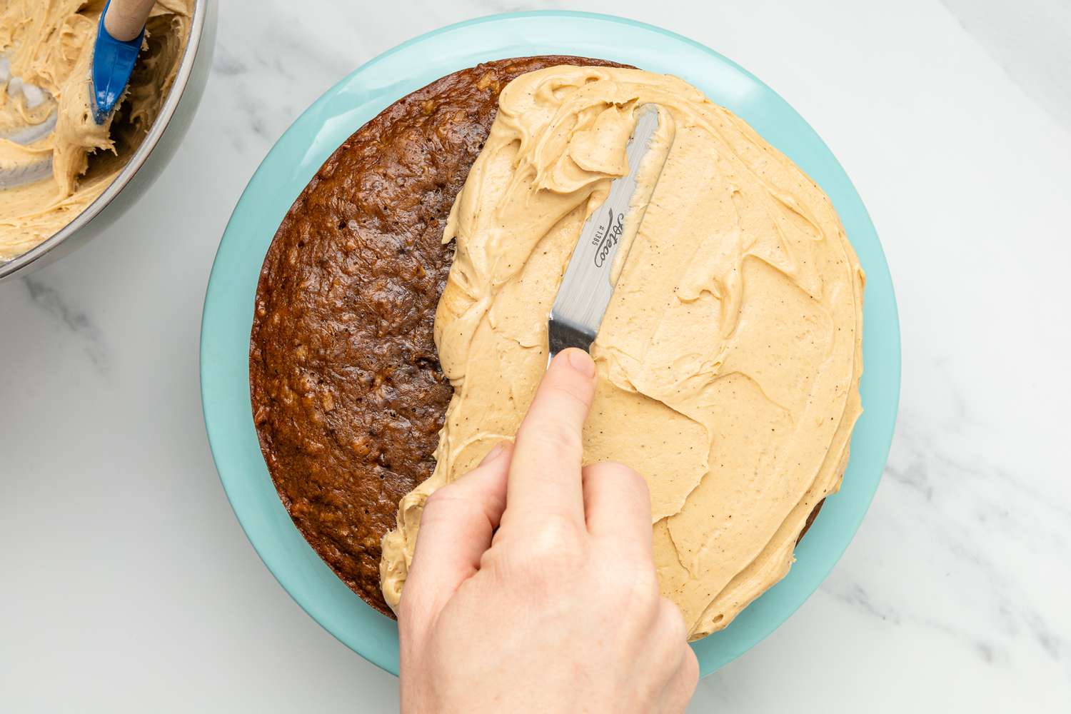 Icing Spread Onto Coffee Coconut Banana Bread Cake Using an Offset Spatula