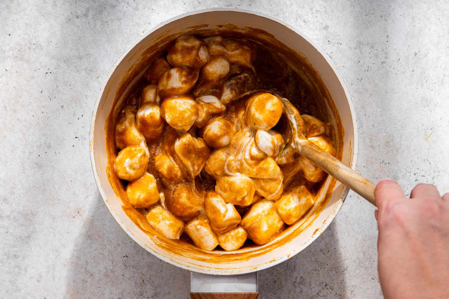 Marshmallows melting into the pan with pumpkin pie mixture for no-bake pumpkin pie recipe