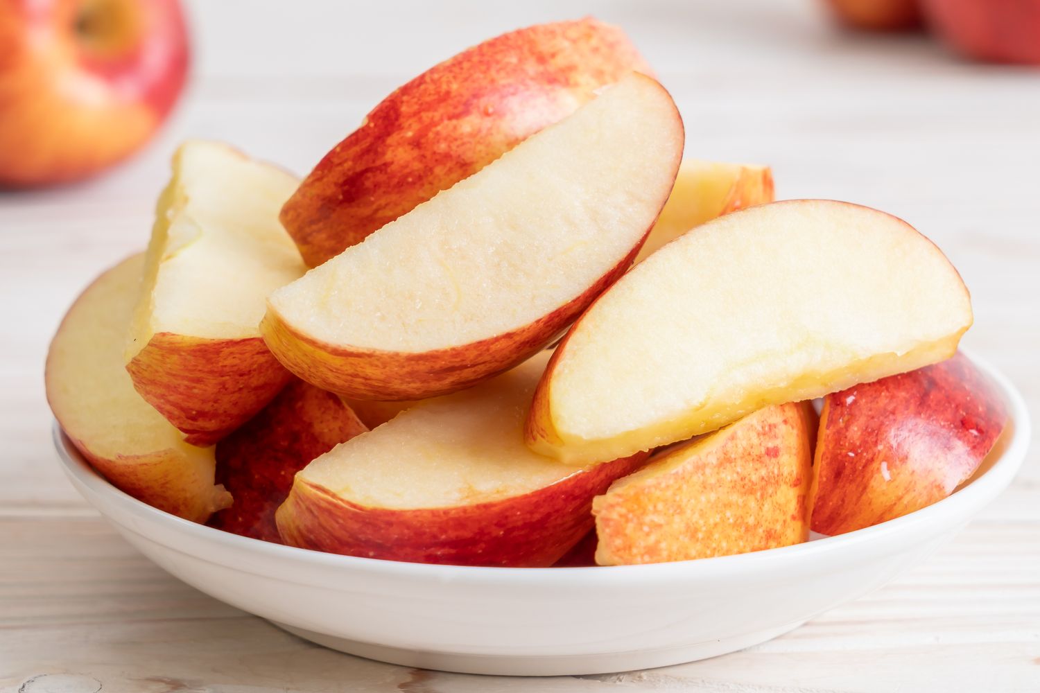 A bowl of sliced apples on a table