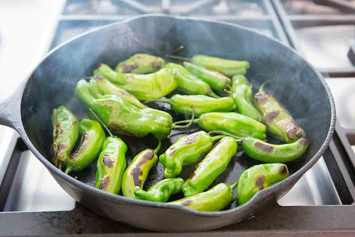 sauté shishito peppers in frying pan