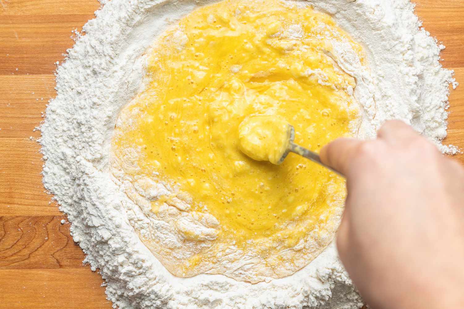 Fork Used to Break Down Eggs and Slowly Mix With Flour for Homemade Tagliatelle Recipe