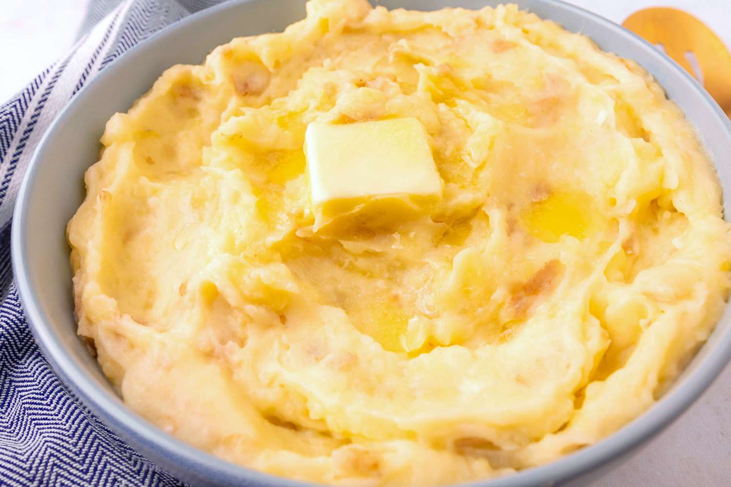 3-Ingredient Garlic Mashed Potatoes in a bowl topped with a pat of butter