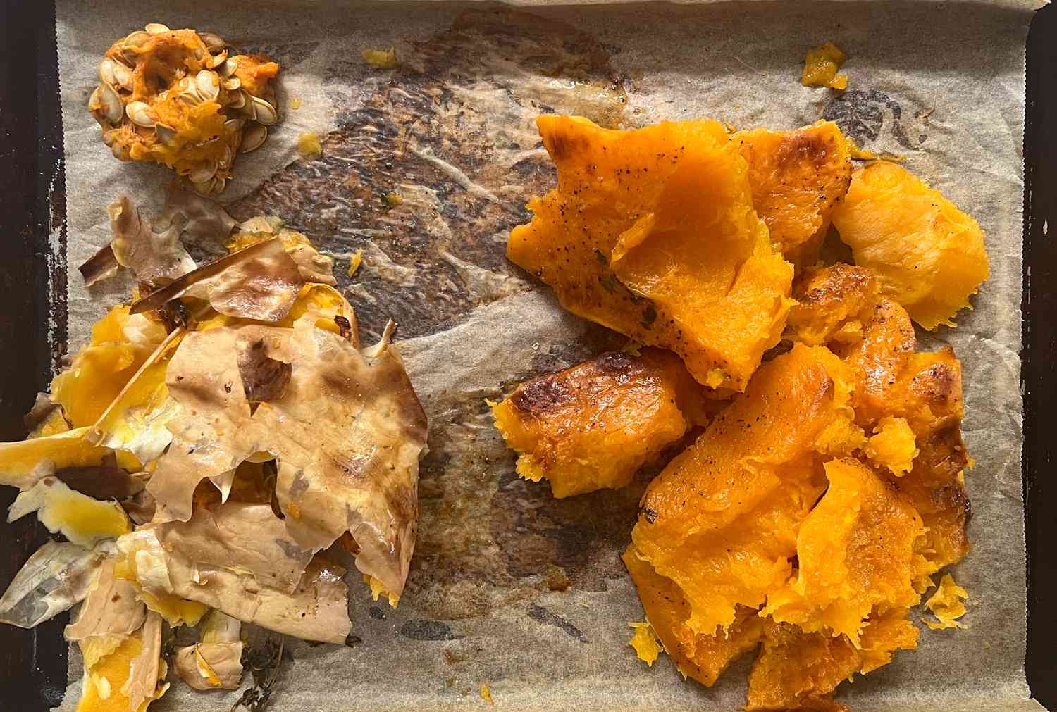 Butternut Squash Skin, Flesh, and Seeds in Separate Pile on a Lined Baking Sheet