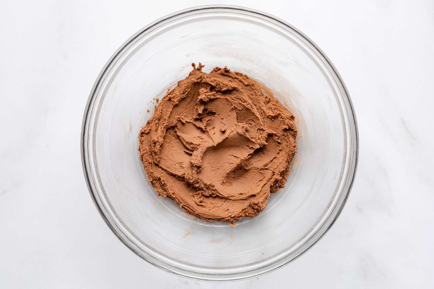melted chocolate added to bowl of dry ingredients for frosting for devil's food cake recipe