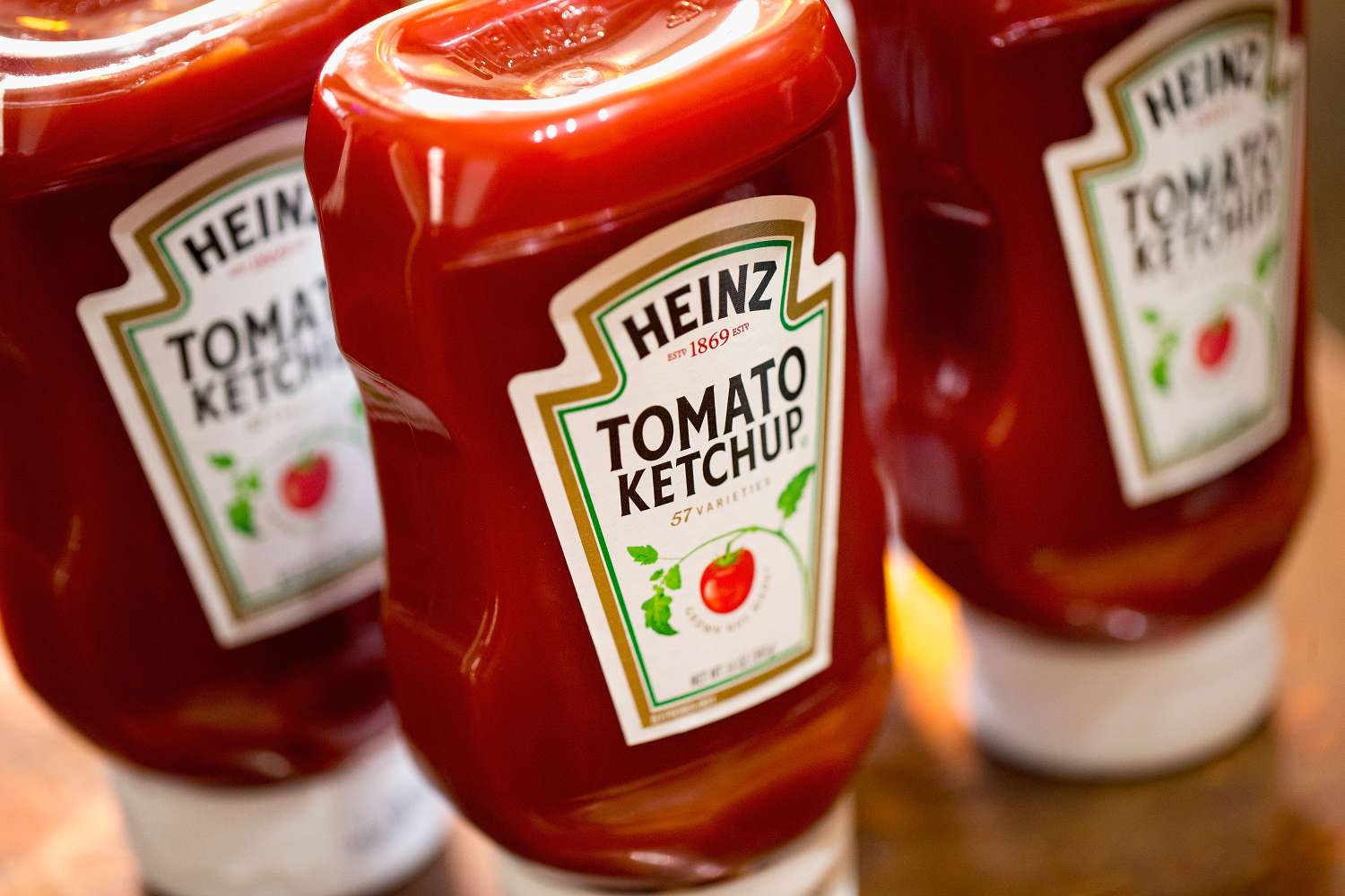 Several bottles of Heinz Tomato Ketchup displayed on a surface