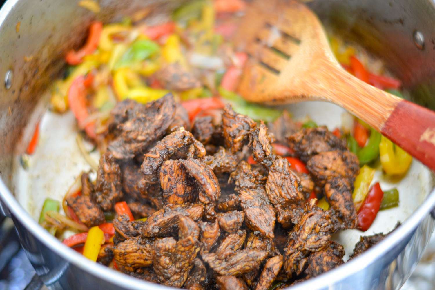 Jerk Chicken Added to Pot of Vegetables for Rasta Pasta