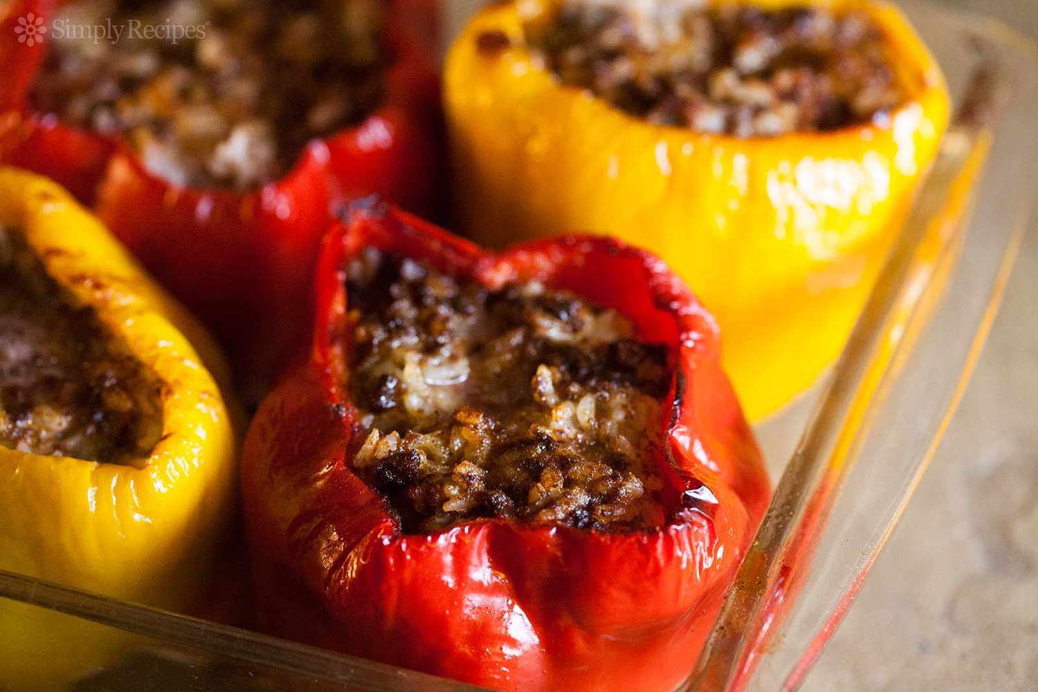 A dish of four baked stuffed bell peppers