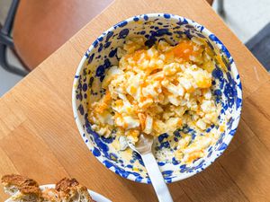 overhead view of egg salad in a bowl with a spoon