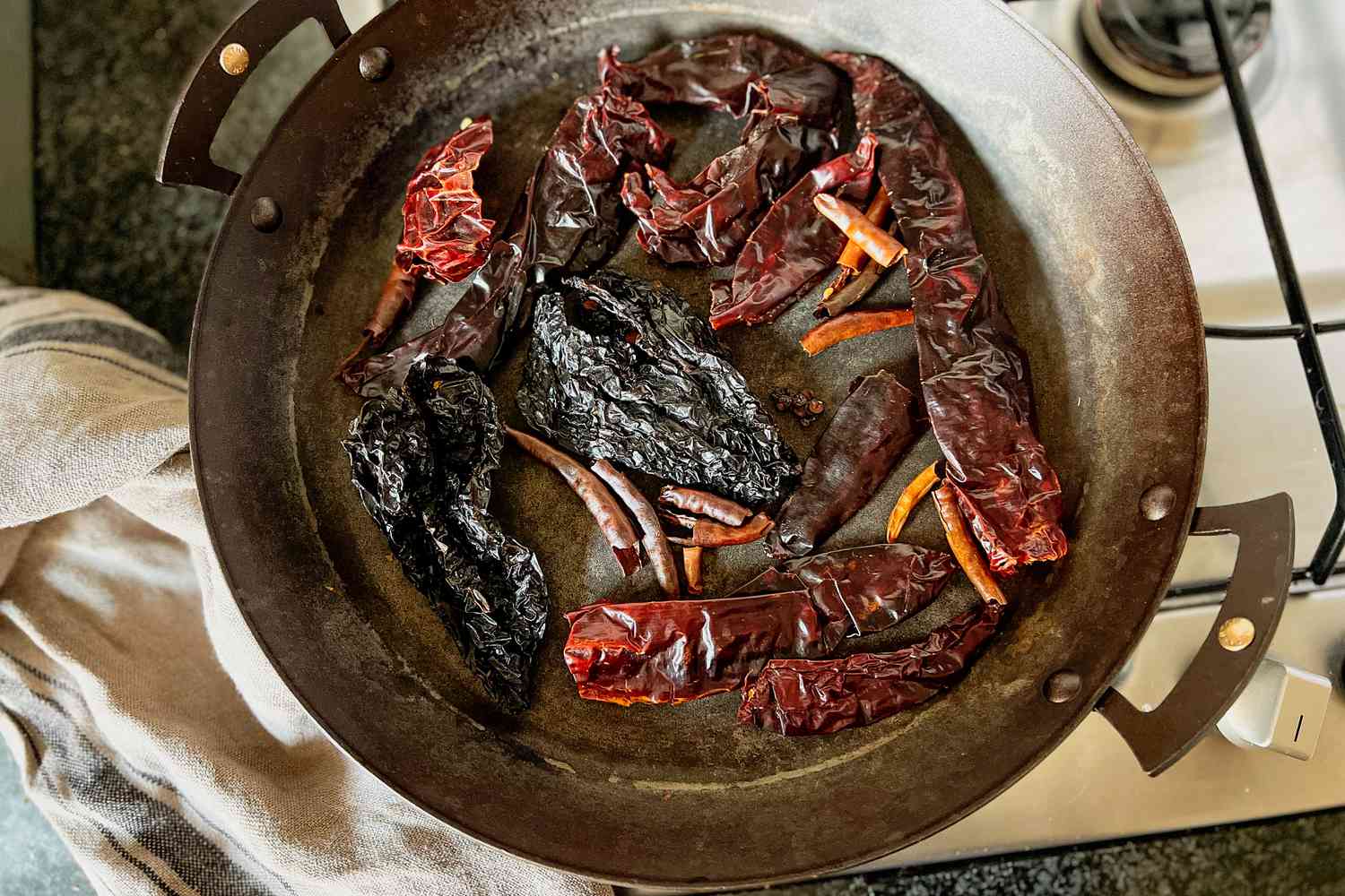 Peppers being toasted in a skillet