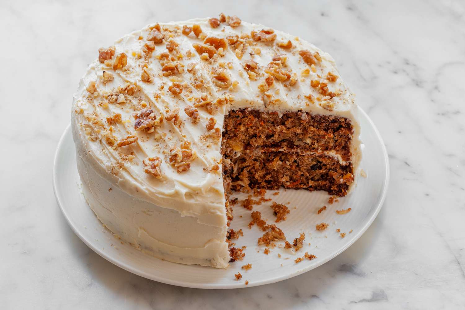 An easy carrot cake recipe with a couple slices missing from the cake.