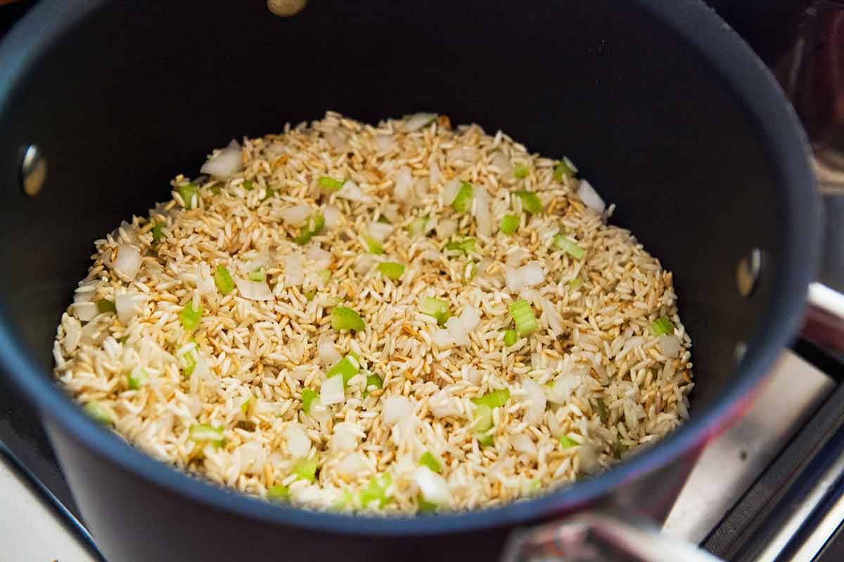 Brown rice and scallions in a sauce pan