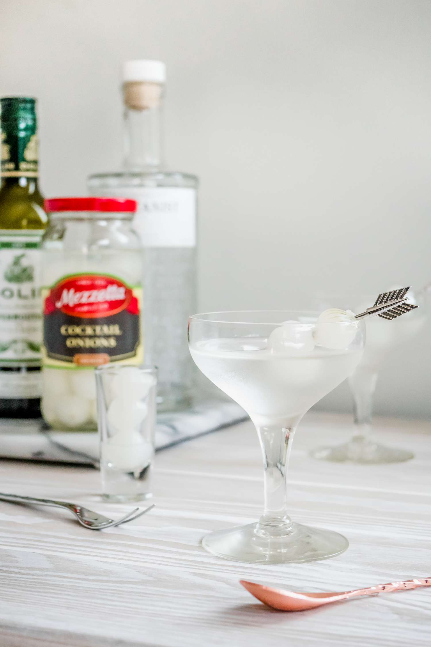 Gibson Cocktail with Pickled Onion Garnish and in the Background, Ingredients to Make the Cocktail
