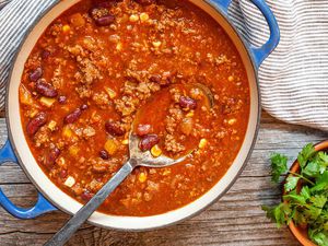 Classic chili in a dutch oven with a serving spoon.