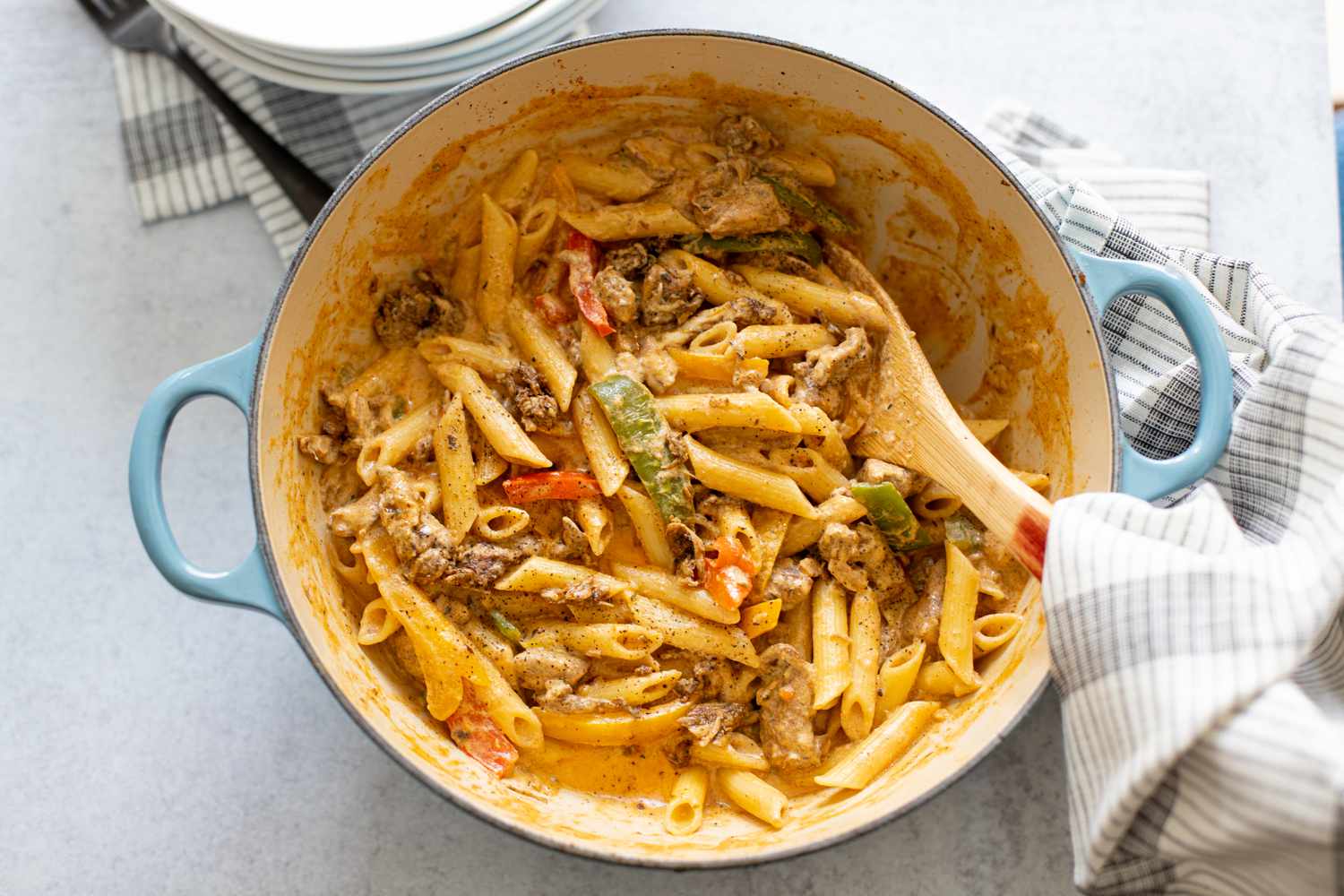 Rasta Pasta with Jerk Chicken in a Pot with a Serving Spoon