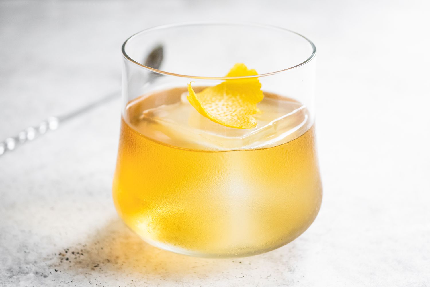 Rusty Nail Garnished with a Lemon Peel