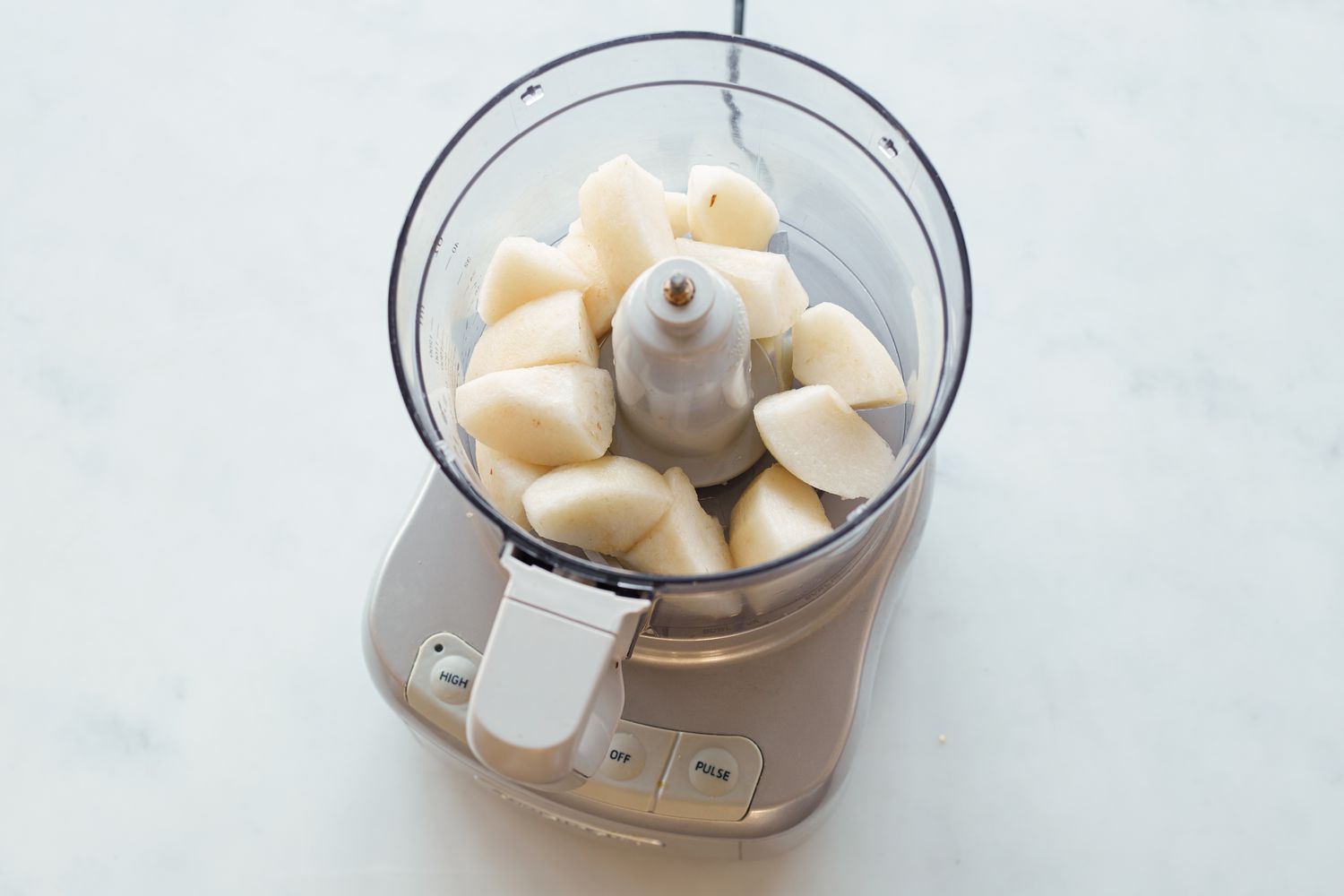 Pears in a food processor to make shortcut Korean braised short ribs .