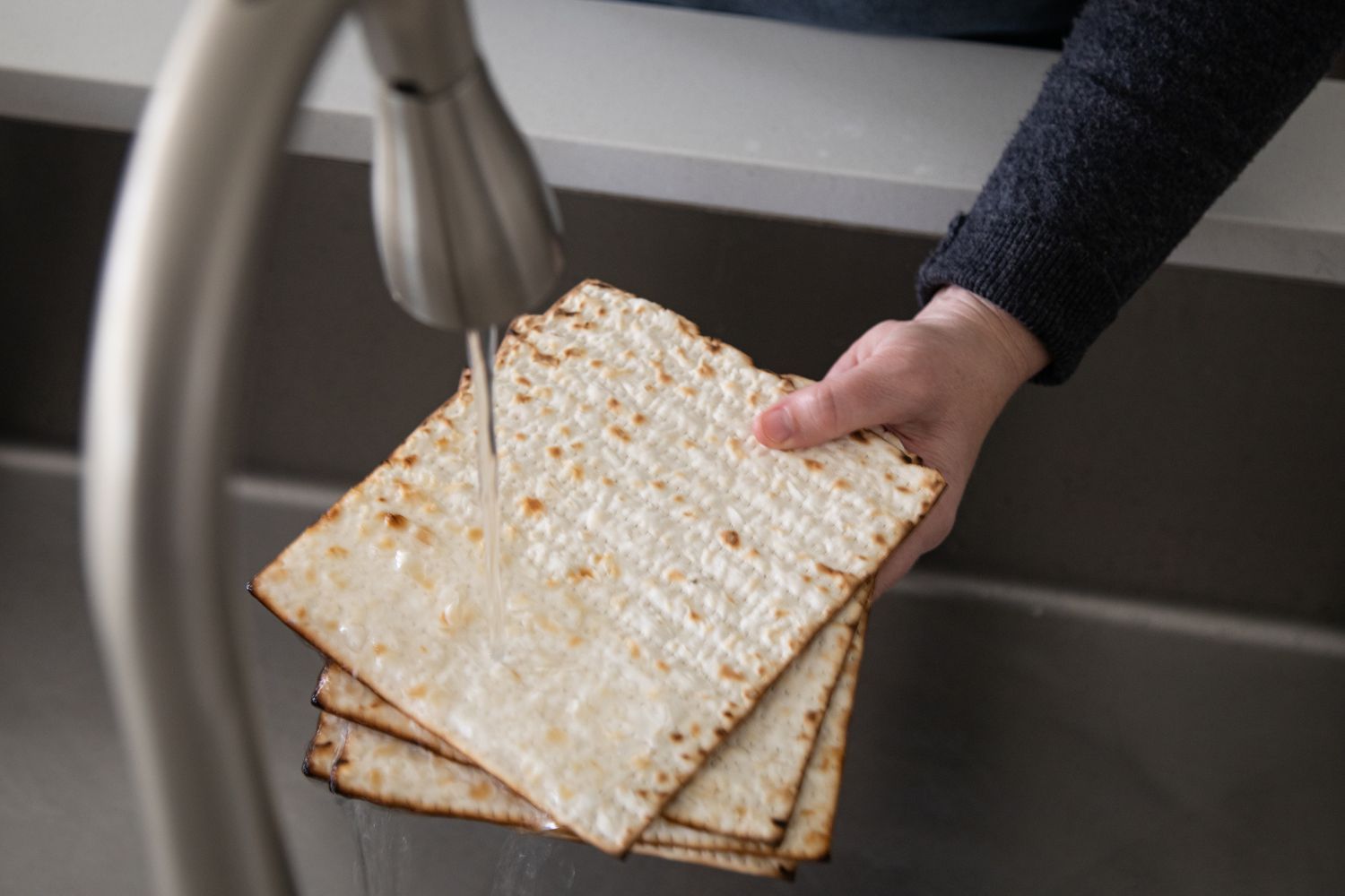 Running water over matzo crackers.