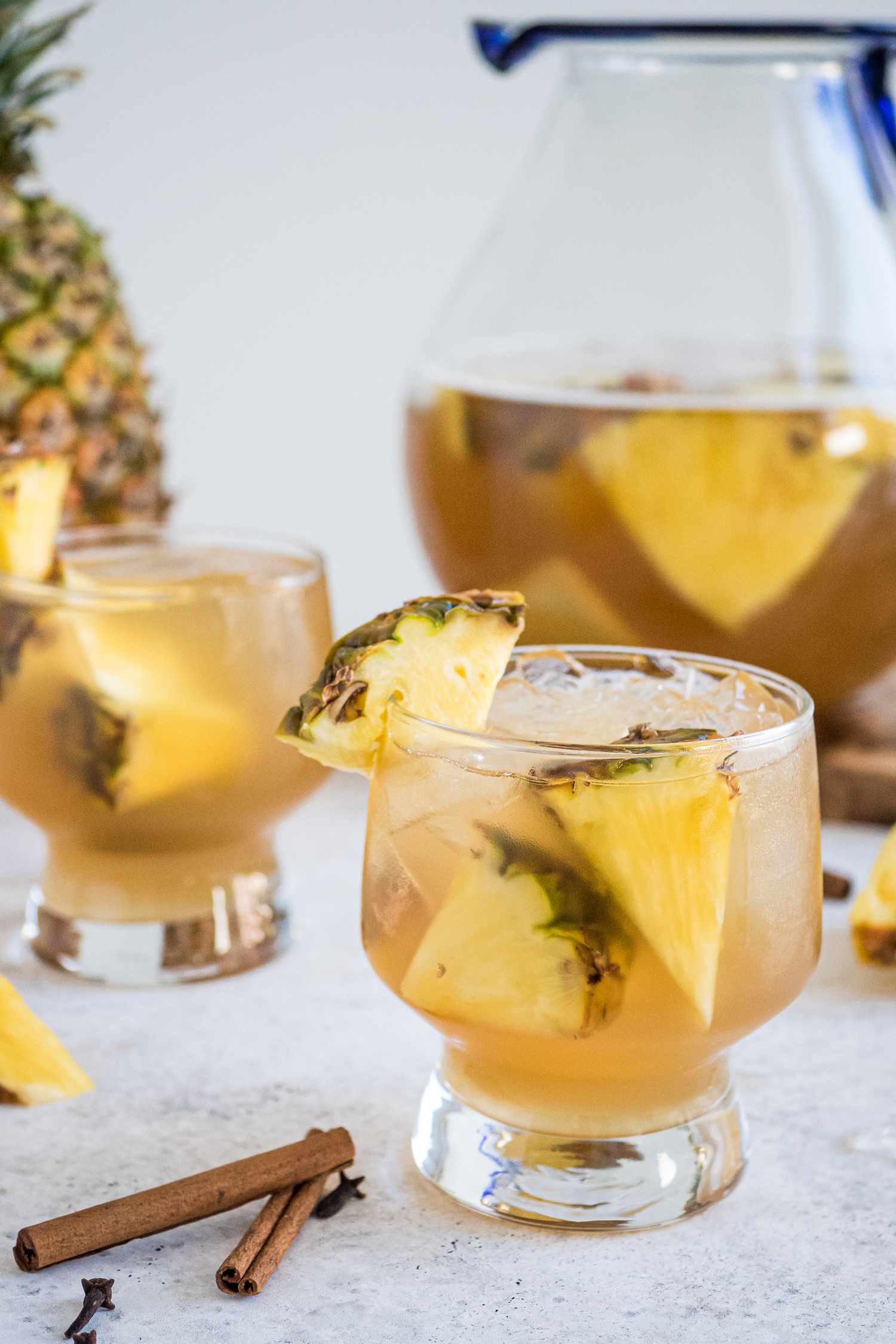 Tepache in two glasses with jug in background.