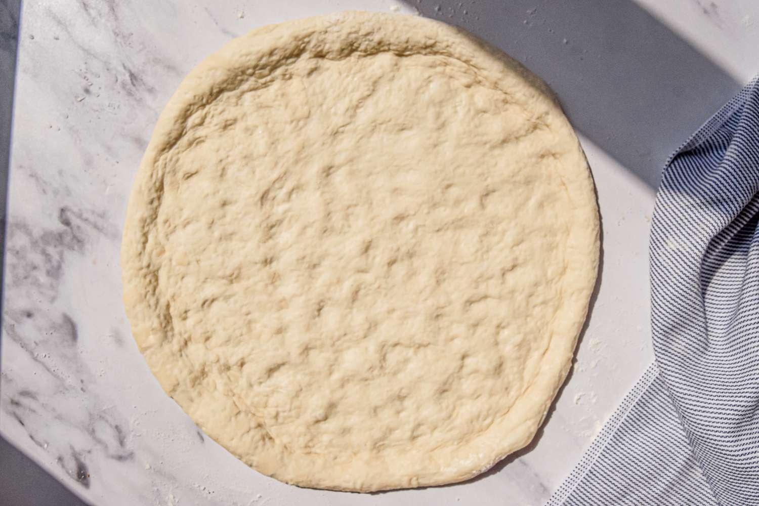 Dough Flattened and Shaped Into a Circle for Pizza, Leaving a Ridge of Dough for the Perimeter
