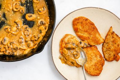 sauce spooned onto the cooked chicken on a plate for chicken marsala recipe