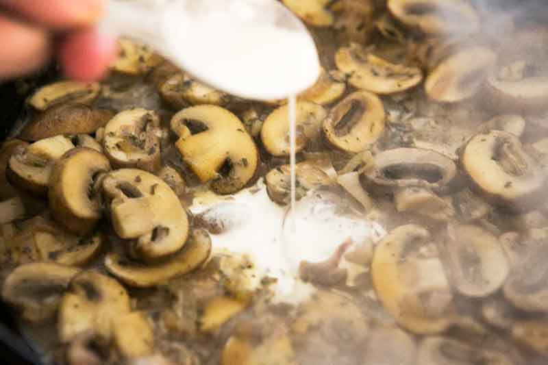 adding cream to mushroom shallot sauce for chicken