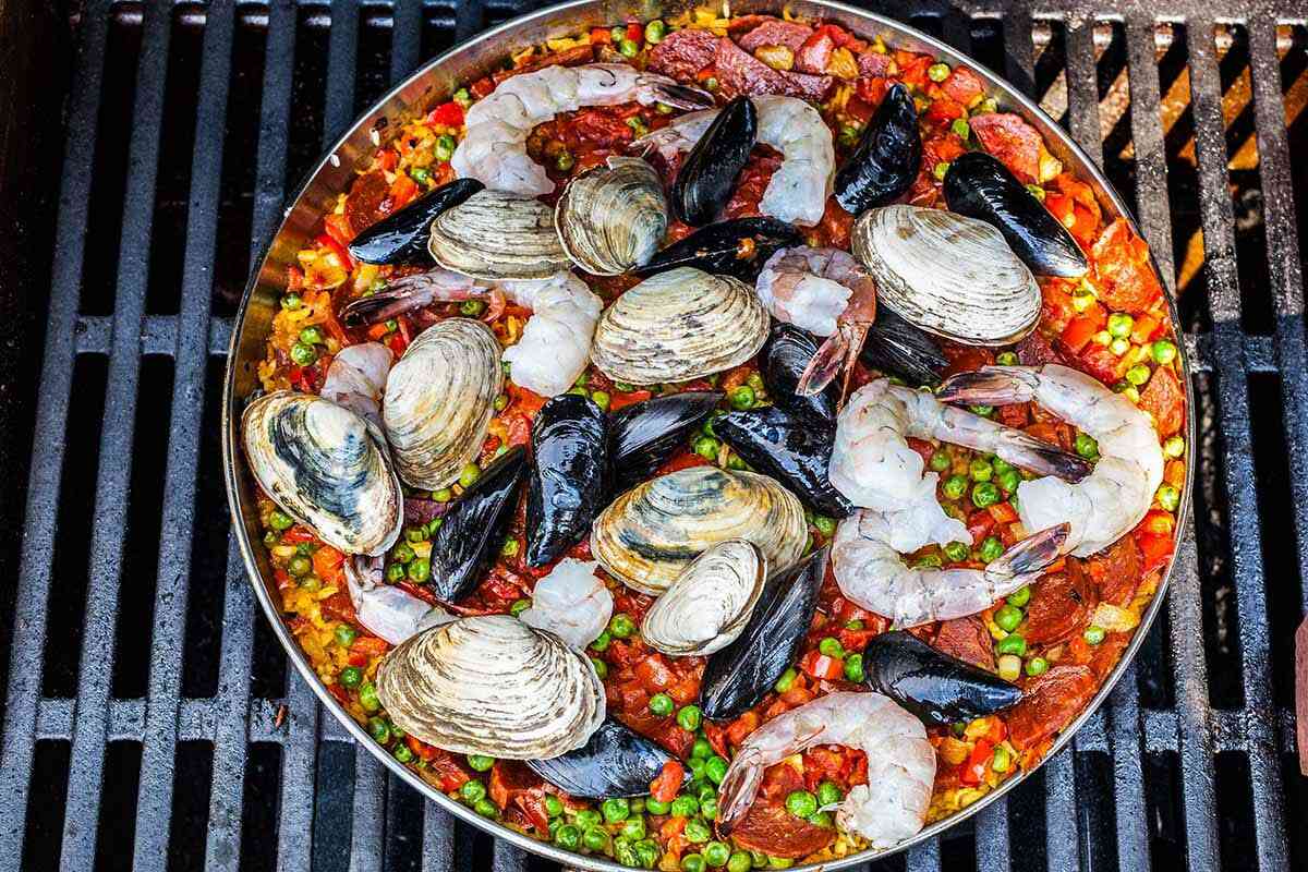 Seafood Paella on a platter cooking on a grill