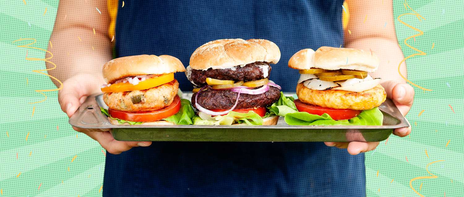Person holding a tray of three burgers. 