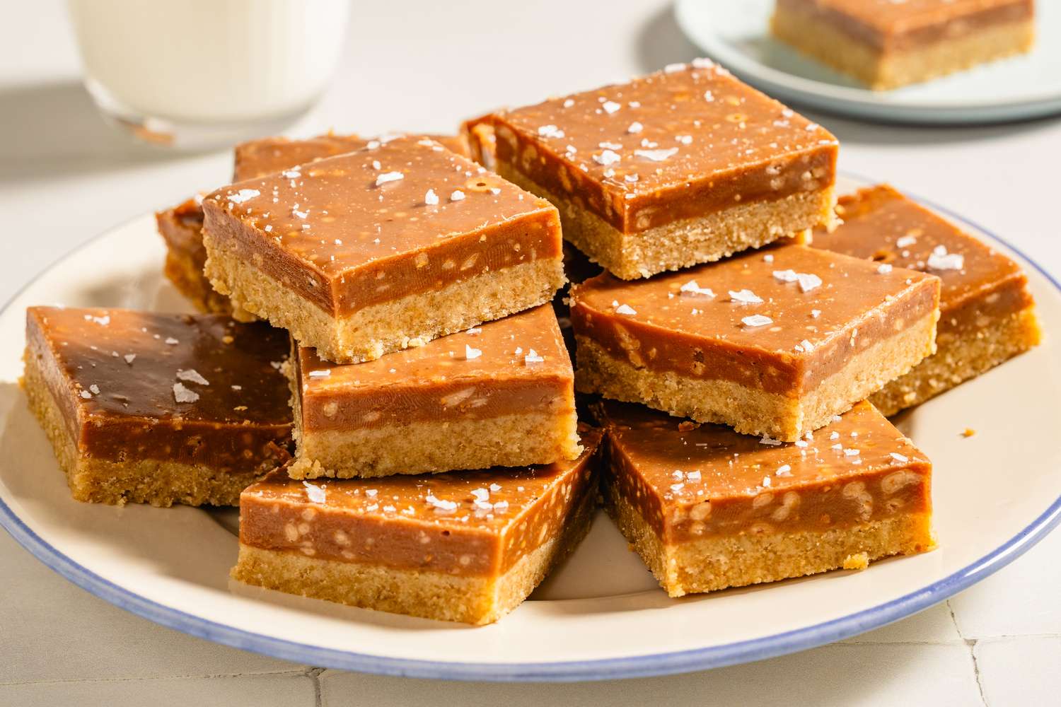 A plate of caramel and shortbread dessert bars sprinkled with sea salt